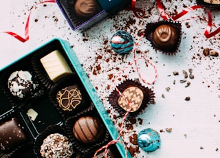 chocolates with box on white surface