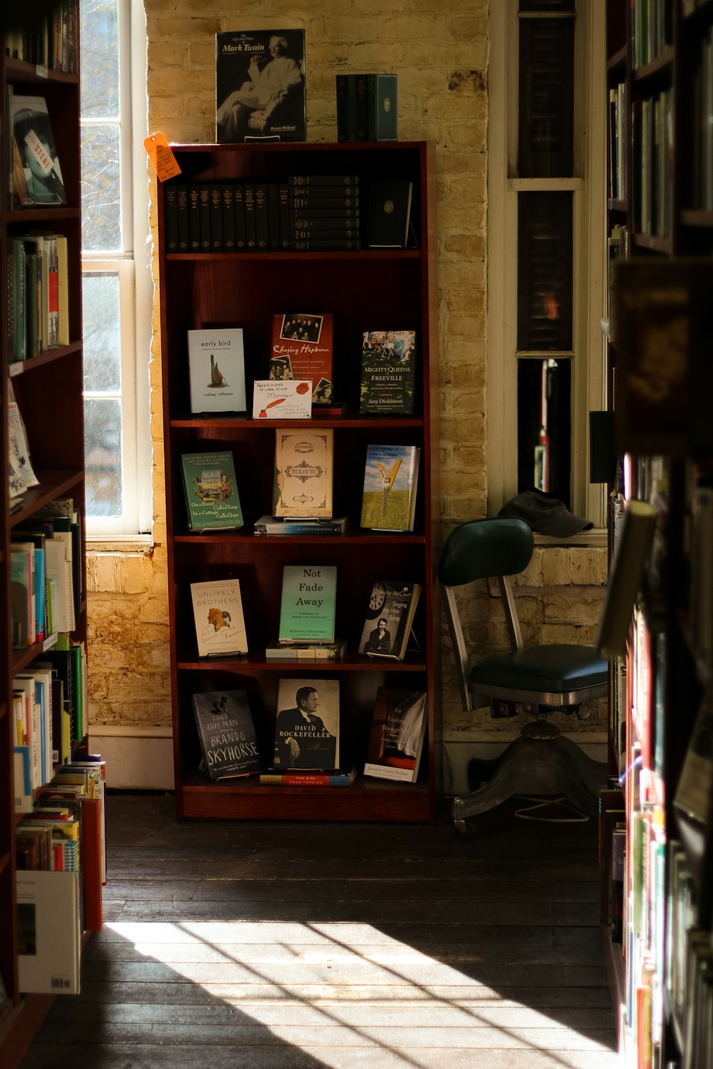 brown wooden shelf with assorted books