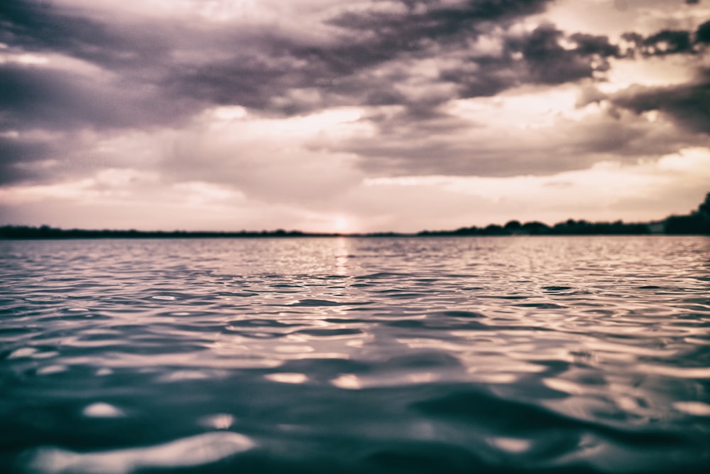 body of water during sunset