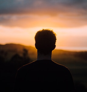 silhouette of a man facing the sunset