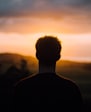 silhouette of a man facing the sunset