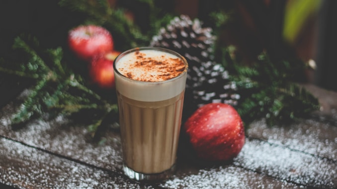 latte field cup beside red apple