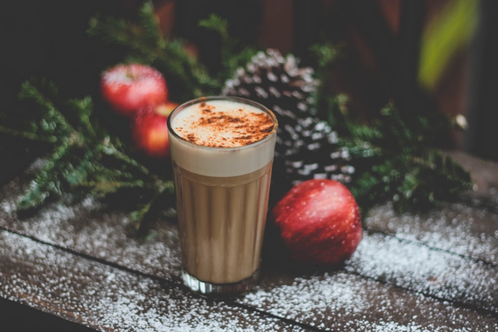 latte field cup beside red apple