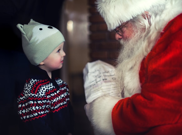 A joyful child writing a letter to Santa.