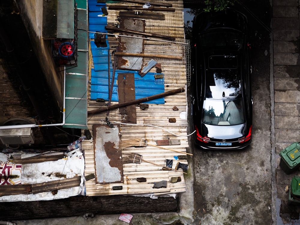 bird's-eye view of black car beside house