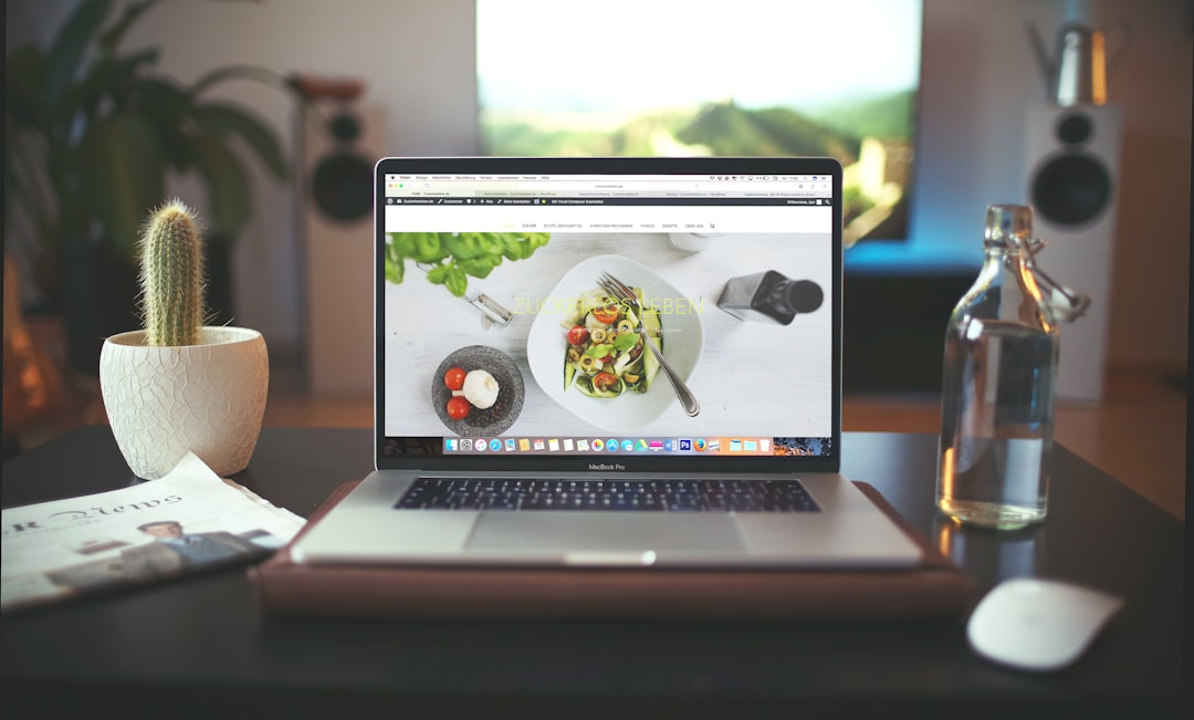 A food blog displayed on the screen of a MacBook on a desk