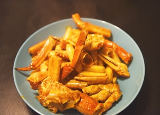 A platter of king crab legs with lemon wedges and fresh herbs ready to serve.