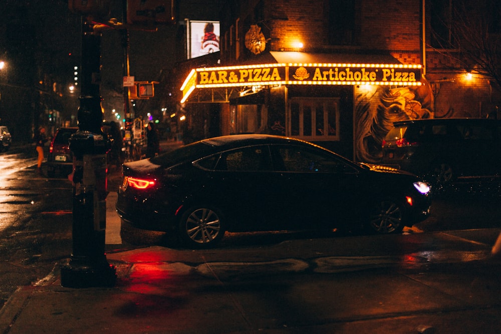 black sedan on road during night time