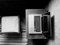 Close-up of a professional working on a laptop in a minimalist office setting.