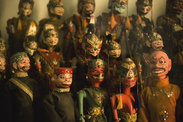 A close-up photo of handcrafted puppets with expressive faces and colorful costumes.