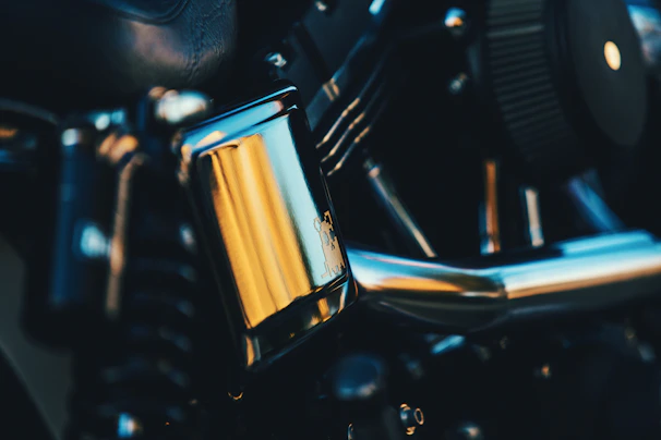 Close-up of a shiny motorcycle engine part with intricate details and a polished finish.