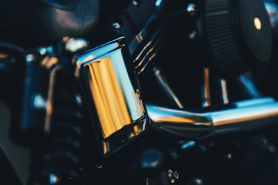 Close-up of a shiny motorcycle engine part on a workbench
