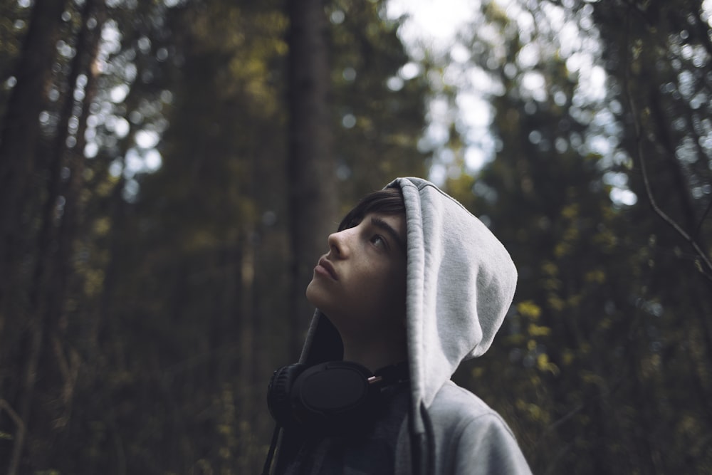 shallow focus photo of man looking at trees