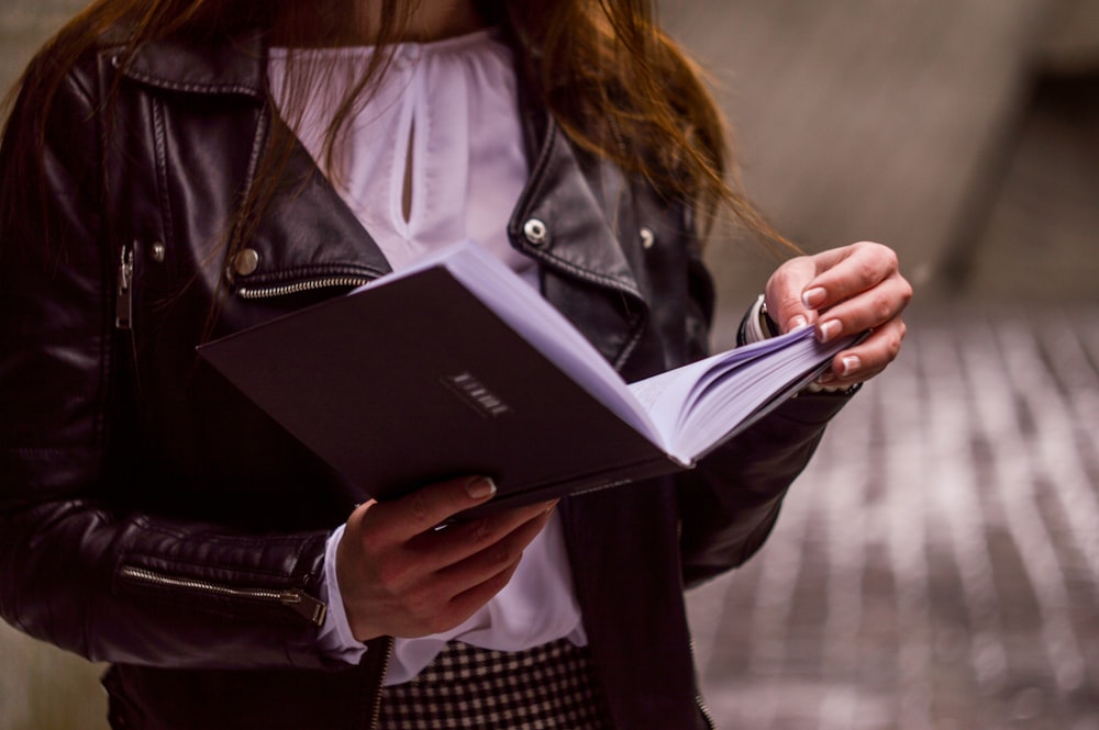 shallow focus of woman reading book