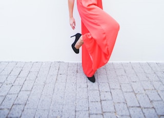 woman wearing black crop top and red silt skirt