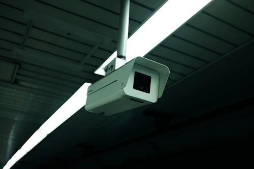 Close-up of a security camera installed on a ceiling mount