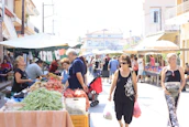Local market scene in Portet-sur-Garonne bustling with fresh produce and friendly vendors.