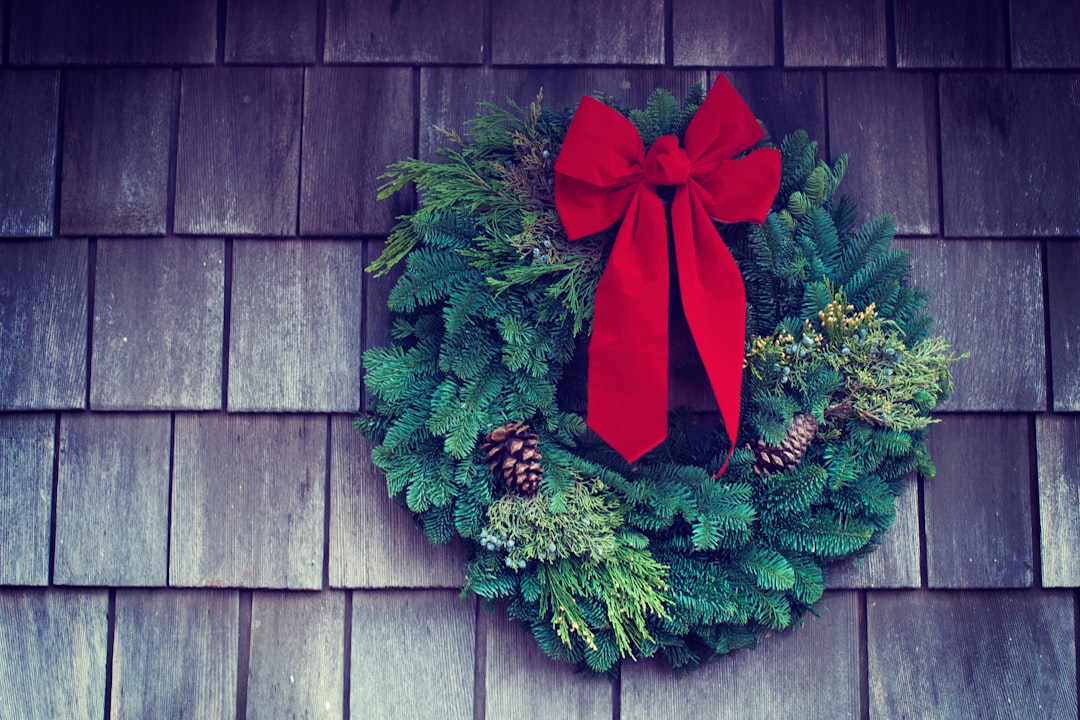 green and red Christmas wreath mounted on wall