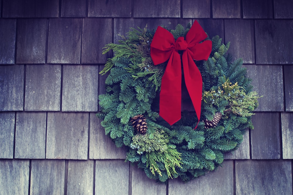 green and red Christmas wreath mounted on wall