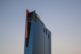 A sleek office building with tinted windows reflecting the city skyline.