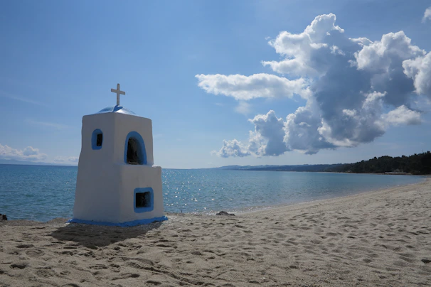 A serene beach chapel decorated with seashells and simple wooden crosses.