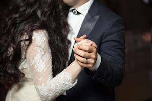 A stylish couple sharing a dance under soft, colorful lights at a weekend party