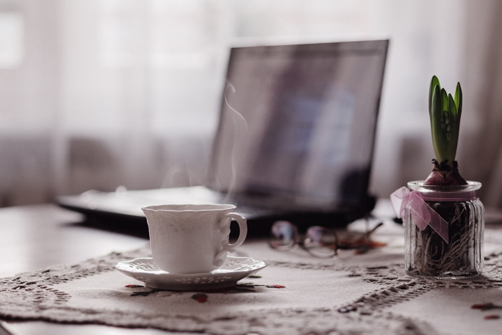 white ceramic mug on table