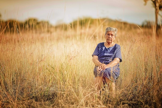 woman sitting on chair and surrounded by grass in Yuriria Mexico