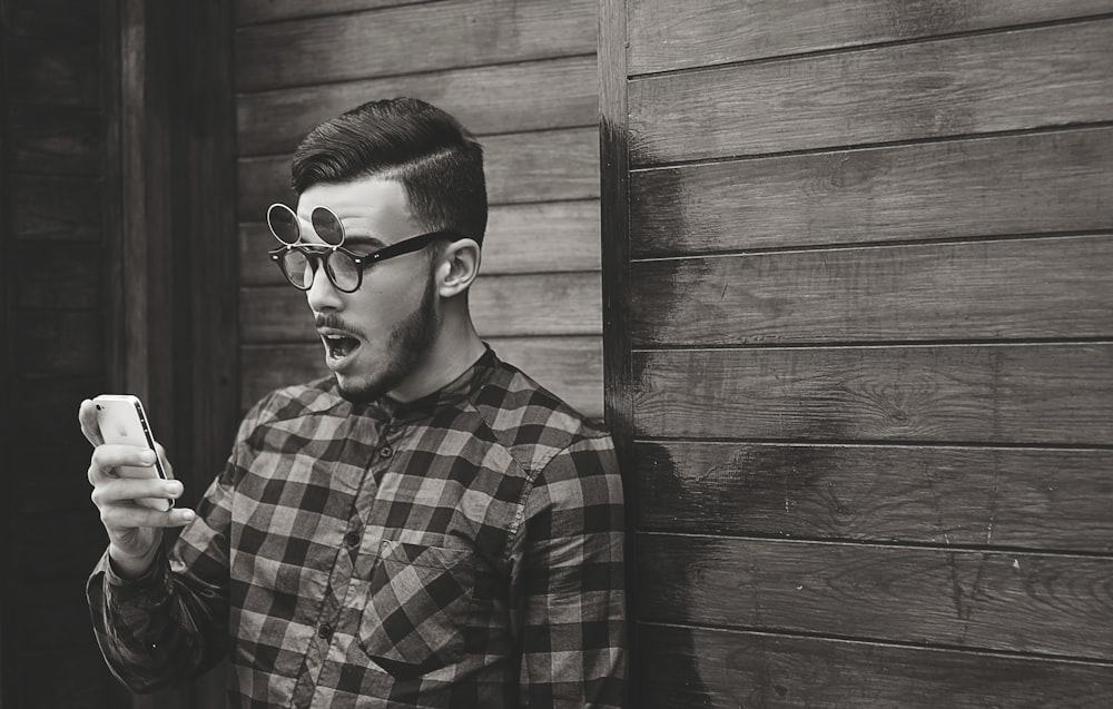 grayscale photo of man wearing plaid dress shirt and sunglasses