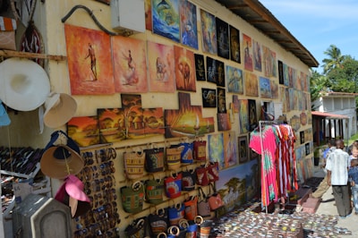 An artwork display featuring colorful paintings and crafts.