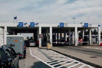 International freight truck crossing a border checkpoint with customs officers.