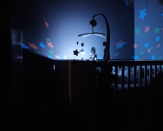 baby's black wooden crib with LED crib mobile