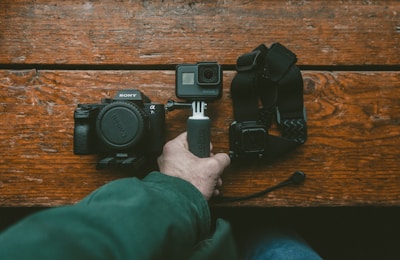person holding action camera