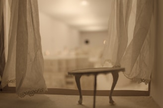 Softly lit room with transparent curtains creating a tranquil and welcoming atmosphere