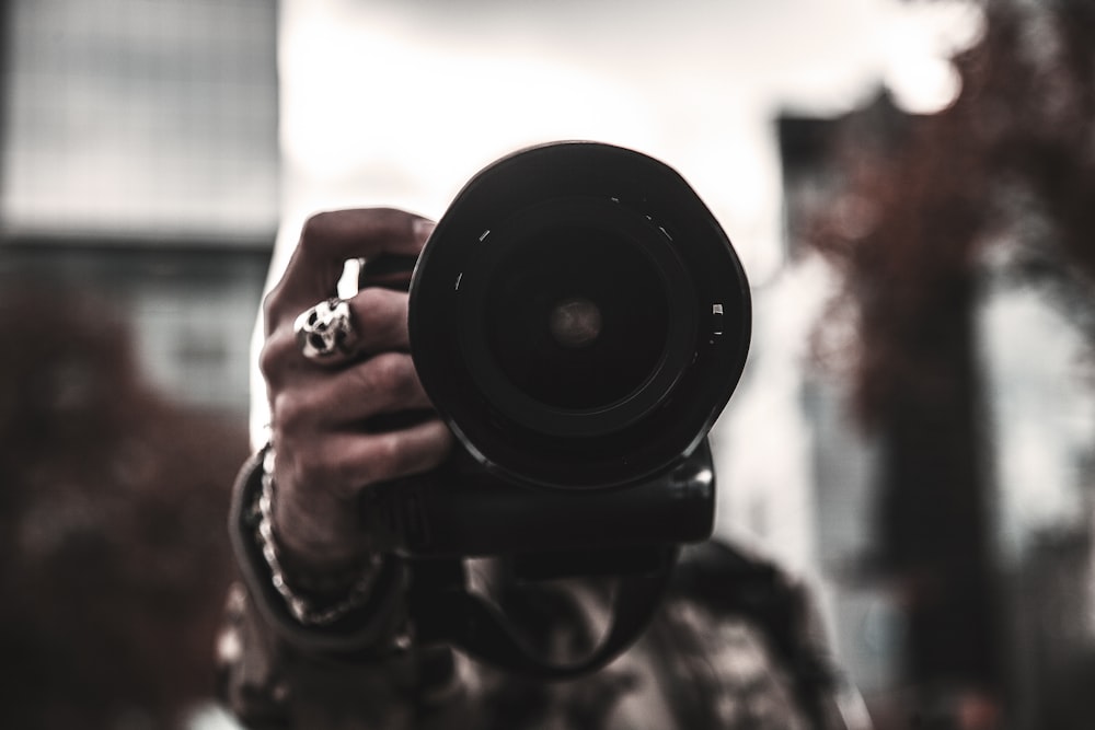 selective focus photo of person holding camera