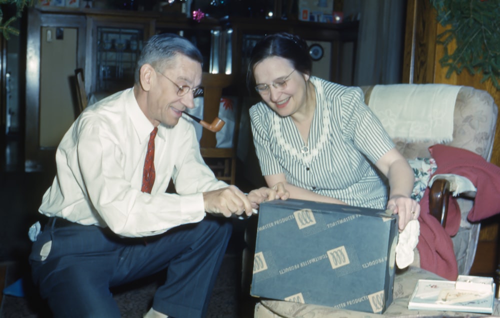 man and woman holding black box