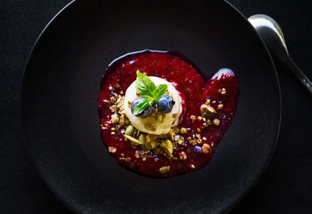 pastry with blueberry topping and sauce on plate