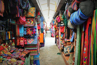 Colorful artisan market stalls in Pisac with vibrant textiles and crafts.
