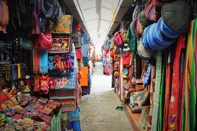 Colorful artisan market stalls in Pisac with vibrant textiles and crafts.