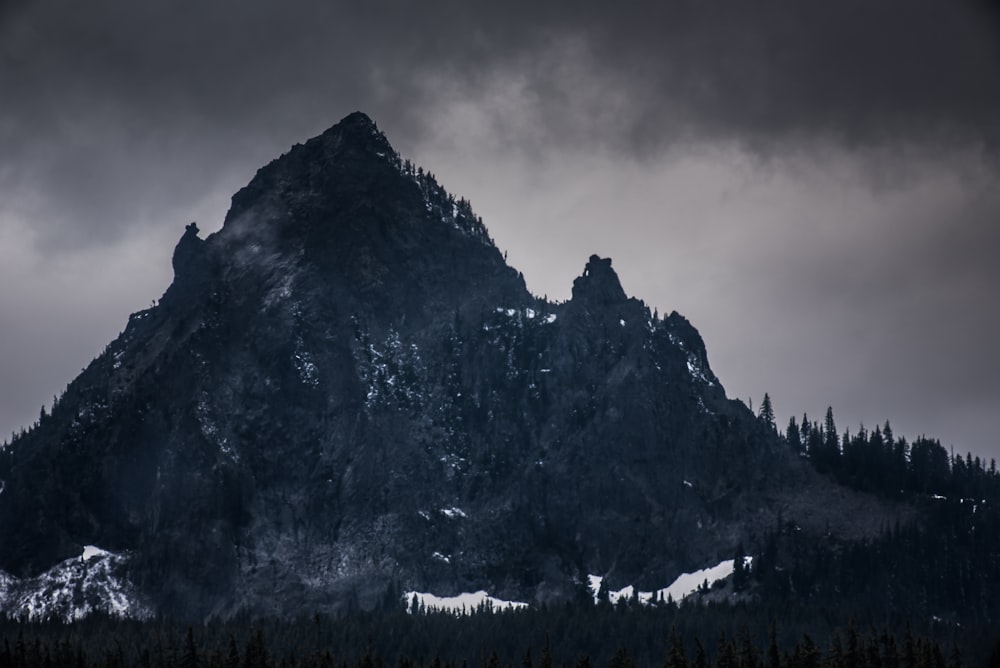 rocky mountain under dim sky