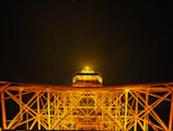 Night view of a completed project illuminated with golden lighting highlighting its design.
