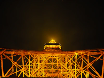 Night view of a completed project illuminated with golden lighting highlighting its design.
