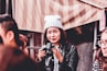 woman in black leather jacket holding DSLR camera