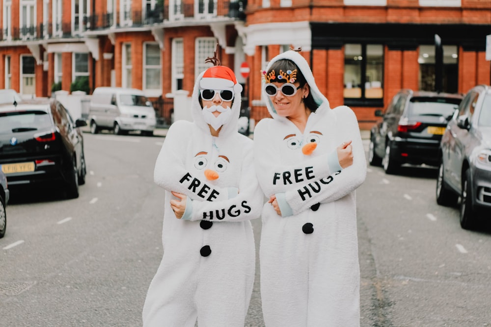 two women wearing coveralls standing next to each other