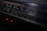A close-up view of a vintage stereo radio cassette recorder. The focus is on the frequency display, which includes various numbers and units such as 540, 600, and 120m. Two small red indicator lights are glowing beneath the display, hinting at the device being powered on.