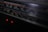 A close-up view of a vintage stereo radio cassette recorder. The focus is on the frequency display, which includes various numbers and units such as 540, 600, and 120m. Two small red indicator lights are glowing beneath the display, hinting at the device being powered on.