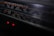 A close-up view of a vintage stereo radio cassette recorder. The focus is on the frequency display, which includes various numbers and units such as 540, 600, and 120m. Two small red indicator lights are glowing beneath the display, hinting at the device being powered on.