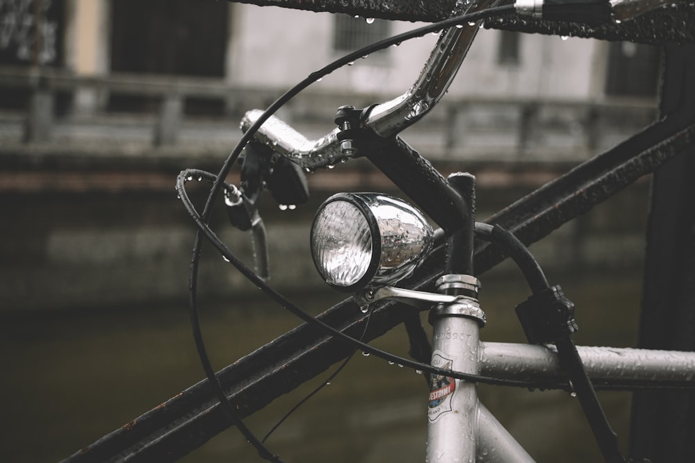 gray bicycle leaning on black metal fence at daytime