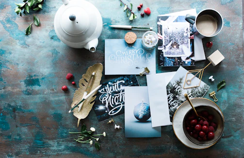 A cozy flat lay of colorful gift bundles, mugs, and apparel arranged on a wooden table.