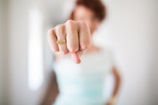 woman showing gold-colored ring